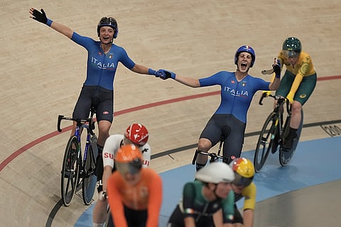 Chiara Consonni, left, and Vittoria Guazzini celebrate winning the gold medal in the women's madison event